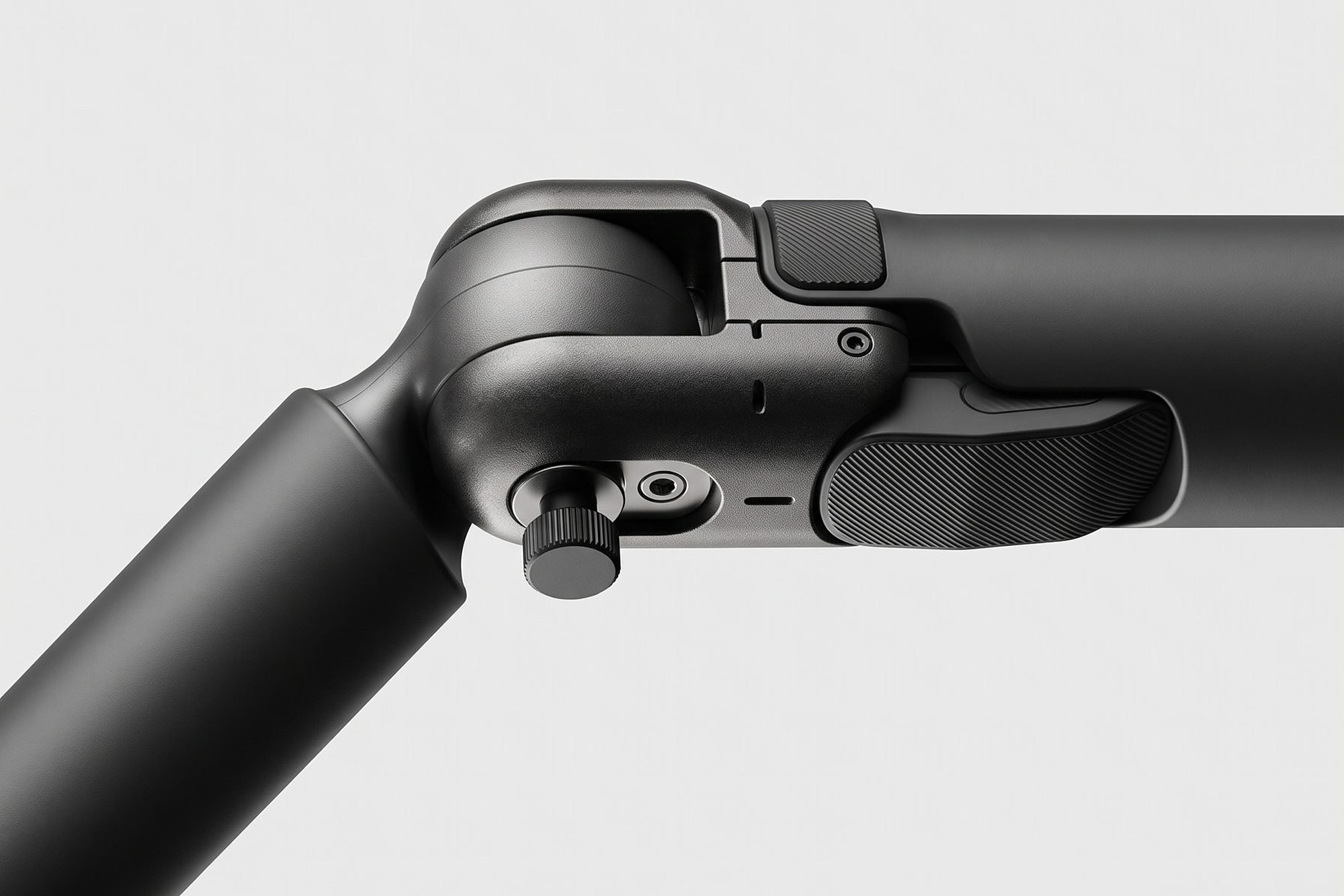 Black articulated arm joint with a knurled adjustment knob and rubber grips